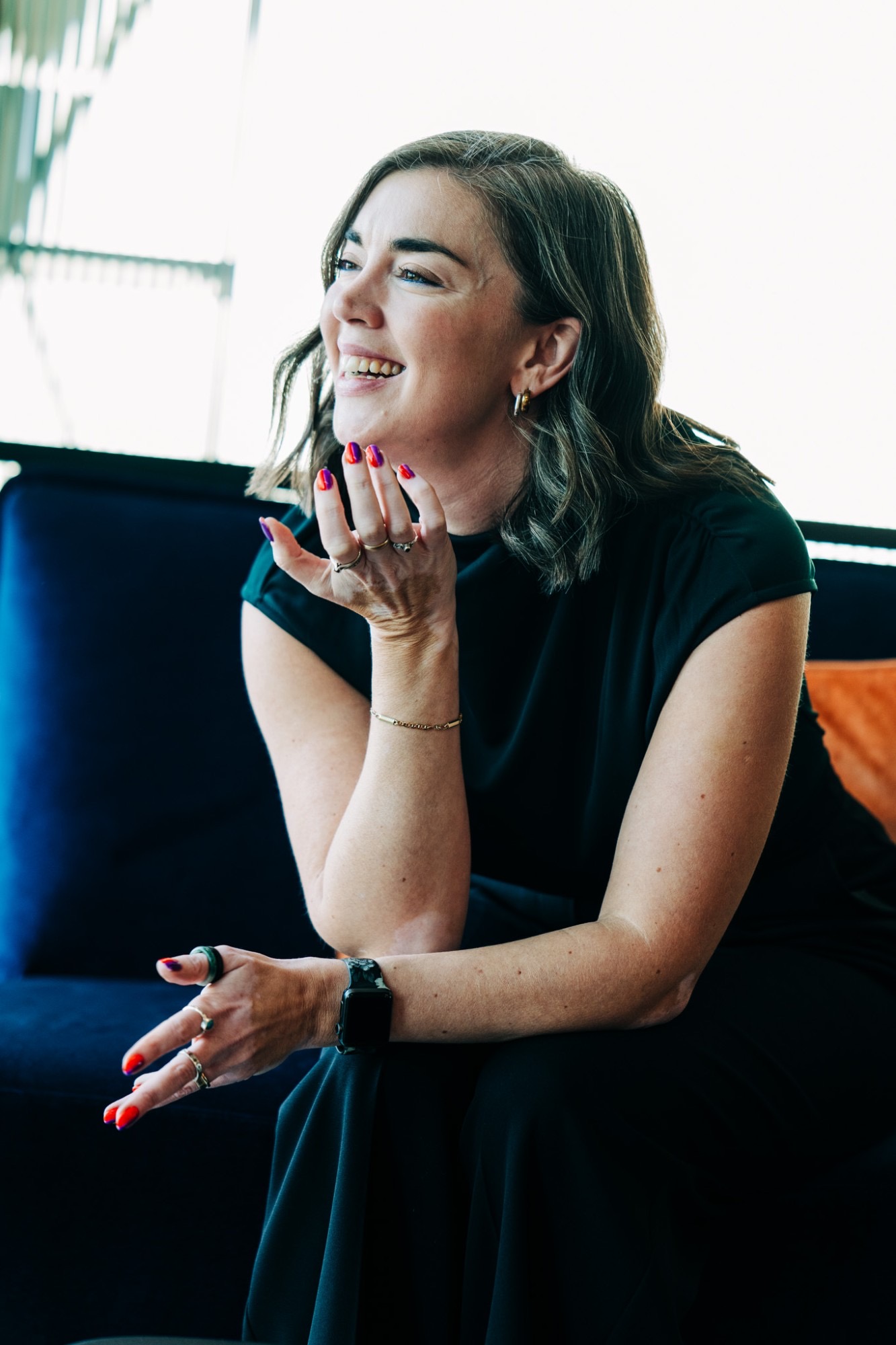 Jancis Dunn laughing mid-conversation, one hand raised