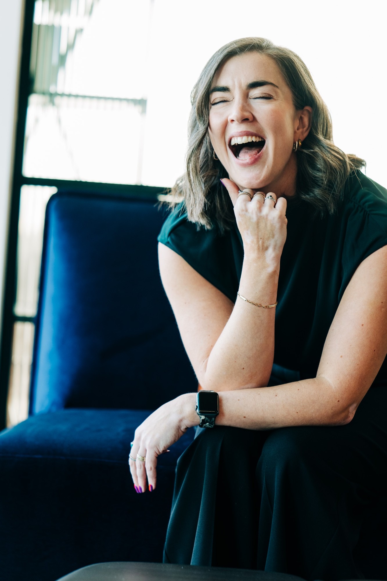 Jancis Dunn resting her chin on her hand, smiling at the camera